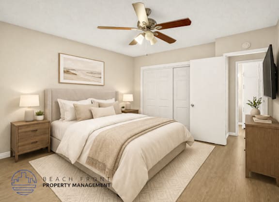 A bedroom with a large bed, a ceiling fan, and a painting on the wall.