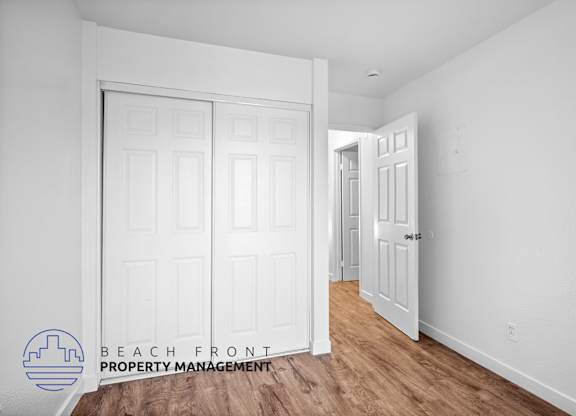 a bedroom with two closets and a door to a hallway