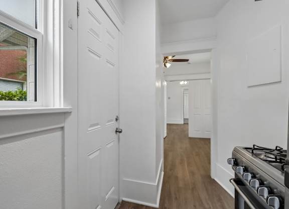 A white hallway with a stove on the right.
