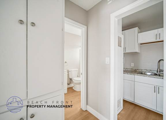 A white bathroom with a toilet and sink.