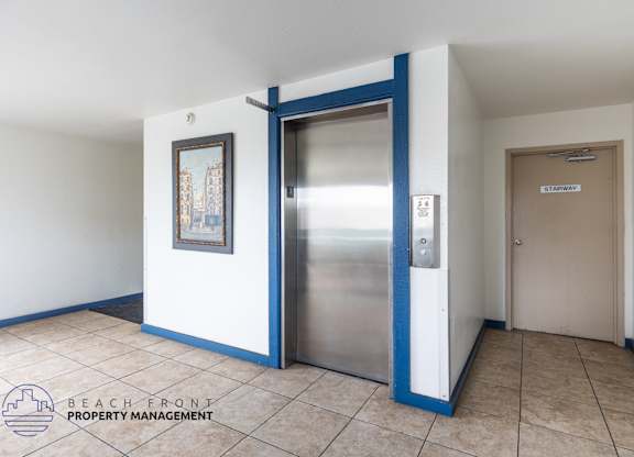 A hallway with a blue door and a sign that says