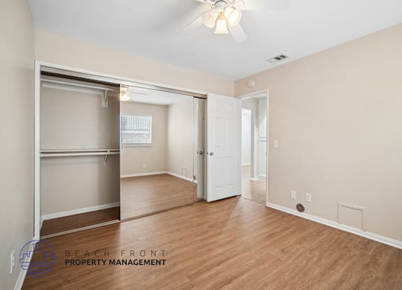 A room with a sliding door and a white door.