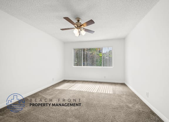view of large bedroom with natural light and ceiling fan