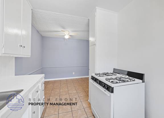 A kitchen with a stove and cabinets.
