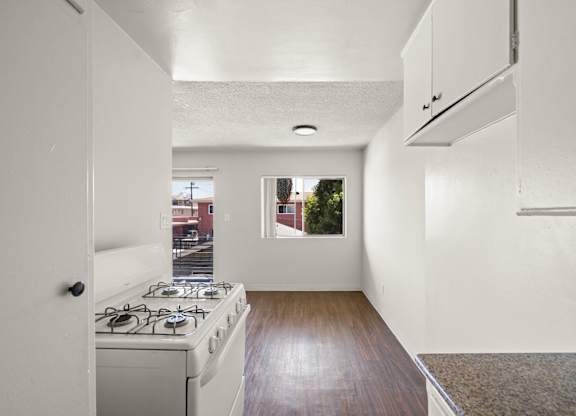 A kitchen with a stove and a window.