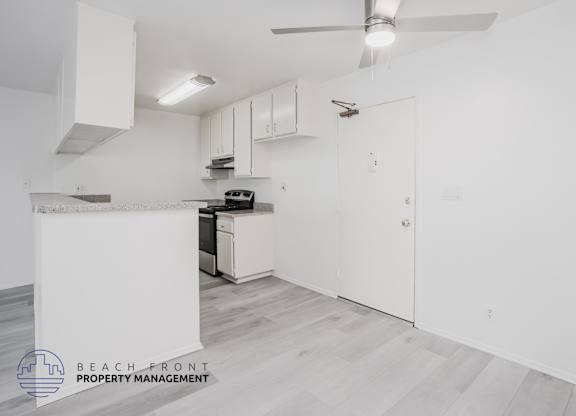 A kitchen area with a stove, oven, and cabinets.