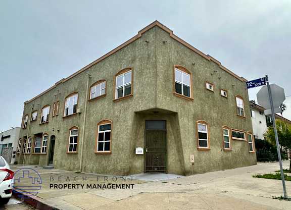 A building with a sign that says Beach Front Property Management.