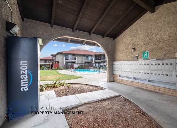A beachfront property management office with a sign for Amazon.