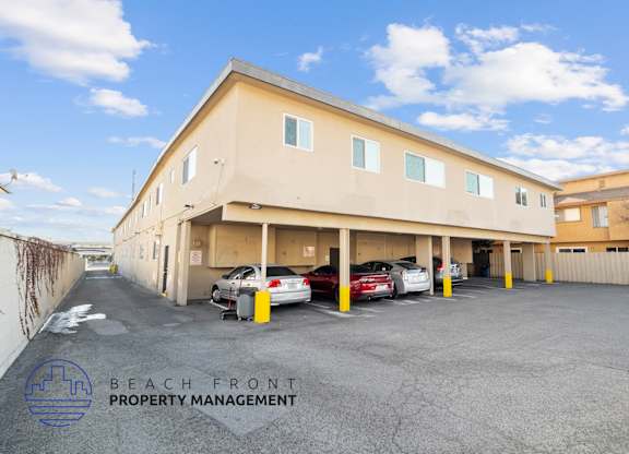 A parking lot with cars and a building with the sign