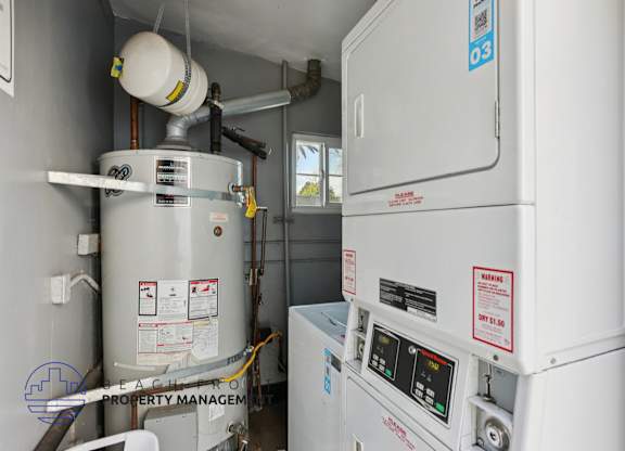 A water heater and a tankless water heater are installed in a room.