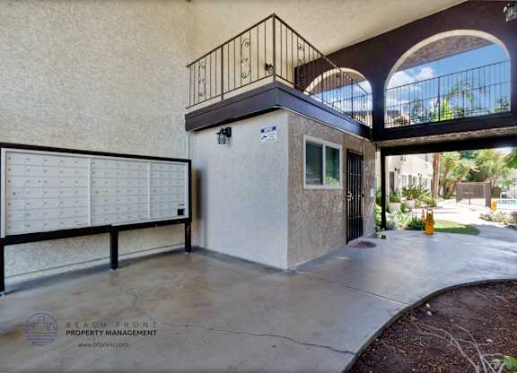 A balcony with a railing and a calendar on the wall.