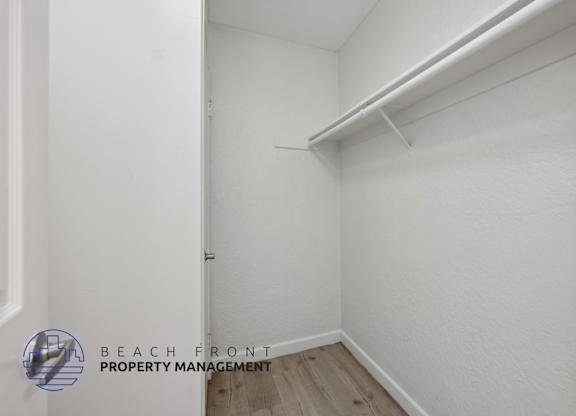 A white room with a logo for Beach Front Property Management.