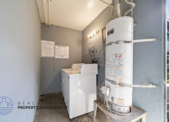 A room with a water heater and a washing machine.
