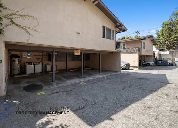 a garage in front of a building with a parking lot