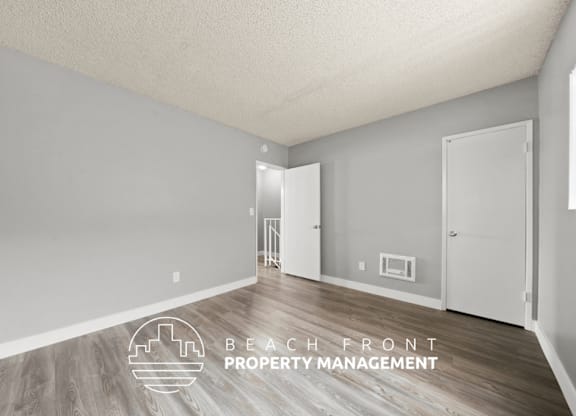 A room with a logo for Beach Front Property Management.