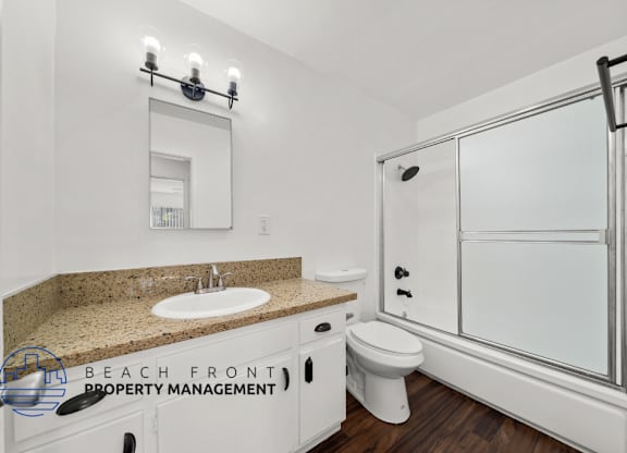view of a large bathroom with shower and cabinets