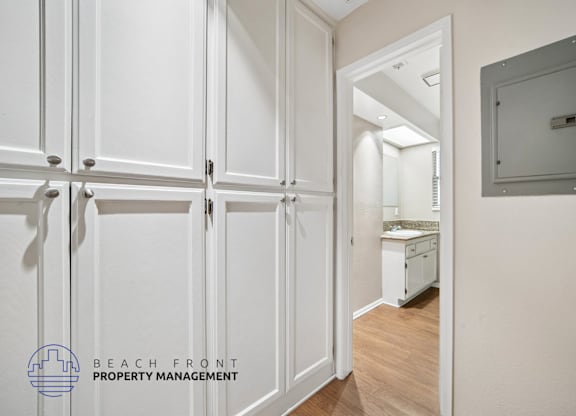 A white door with a handle is open to a kitchen.