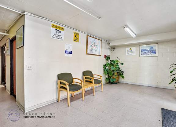 A waiting area with chairs and a sign on the wall.