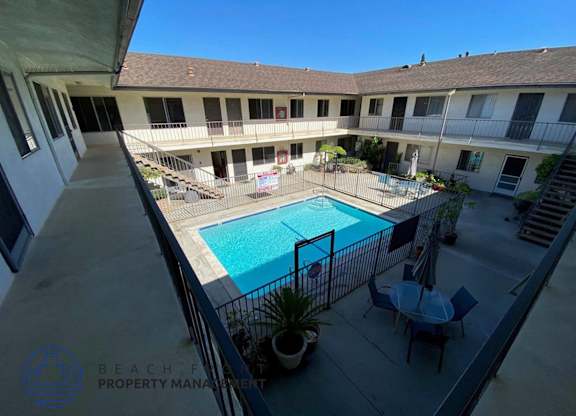 a view of the pool from the balcony of an apartment building