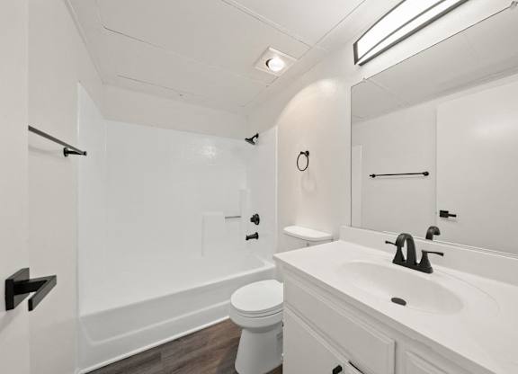 a white bathroom with a sink and a toilet