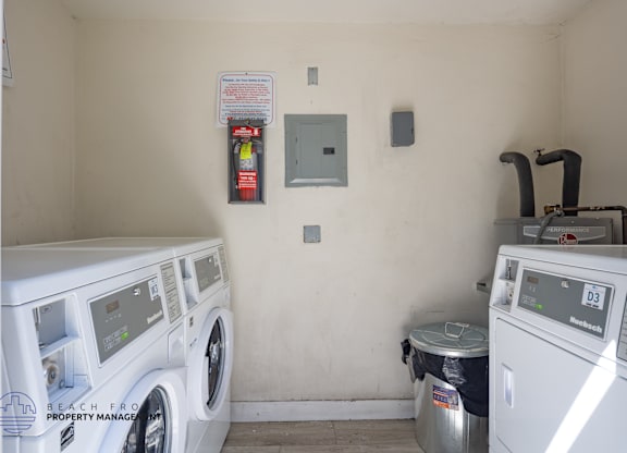 A small laundry room with a washer and dryer.