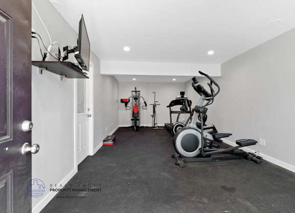 A home gym with a stationary bike and a rowing machine.