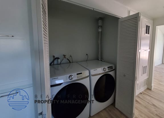 a washer and dryer in a laundry room with a closet