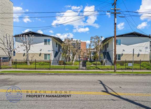 a street view of a row of houses on the side of a street