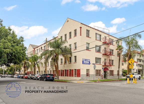 A street view of a building with the sign "BEACH FRONT PROPERTY MANAGEMENT" in front of it.