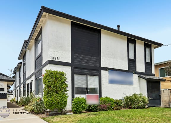 A white and black two-story house with the number 13881 on the front.