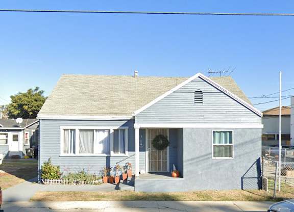 A blue house with a garage door opener on the left.