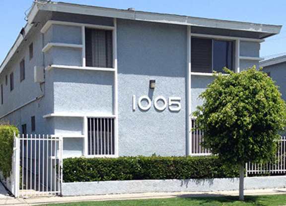 A grey building with the number 1008 on it.