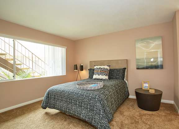 a bedroom with a bed and a window
