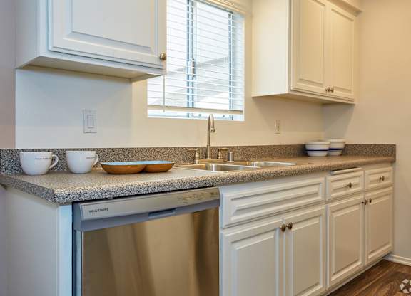 a kitchen with a dishwasher and sink