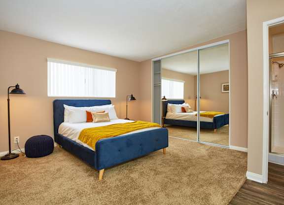 a bedroom with a bed and a mirror
