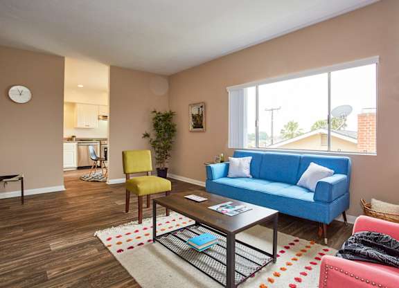 a living room with a blue couch and yellow chair