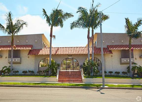 a house with palm trees in front of it