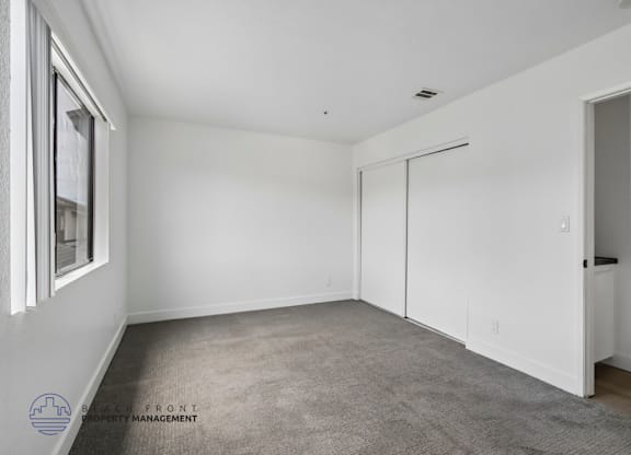 A room with a carpeted floor and white walls.
