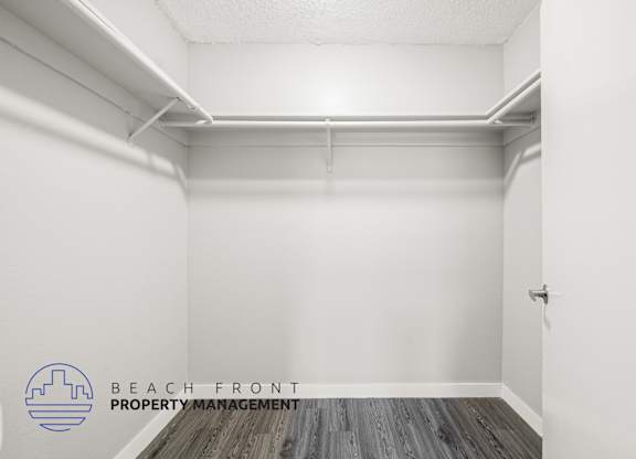 A white room with a logo for Beach Front Property Management.