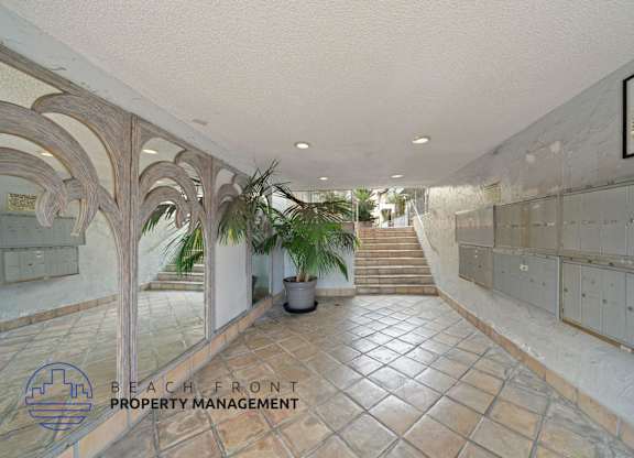 a view of the lobby of a building with tile floors and a staircase