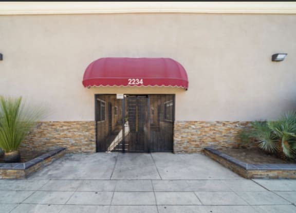 A building with a red awning and the number 2234 on it.