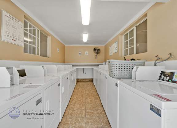 A row of washing machines in a laundromat.