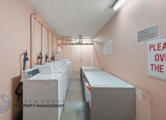 a laundry room with several washes and dryers in it