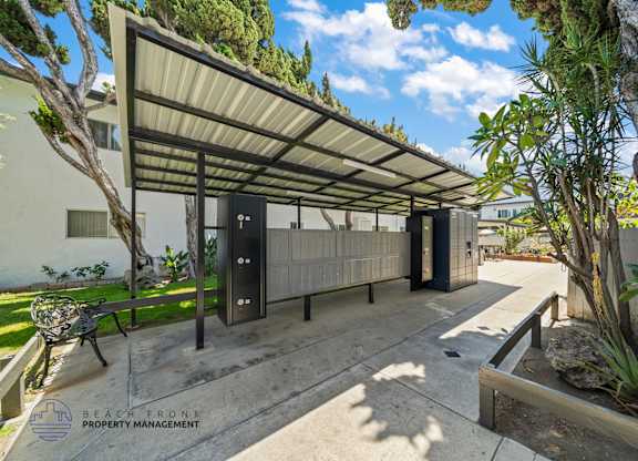 A patio area with a roof and a bench.