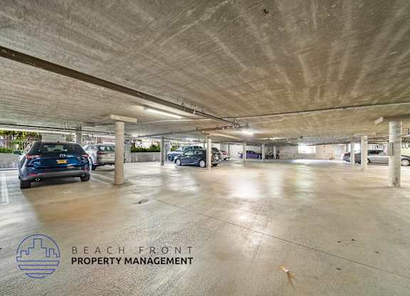an empty parking garage with cars in it