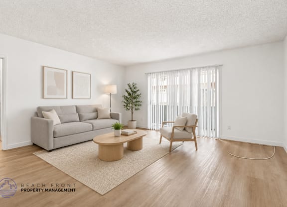 A living room with a grey couch, a wooden coffee table, and a chair.