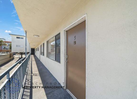 A balcony with a railing and a door with the number 5 on it.