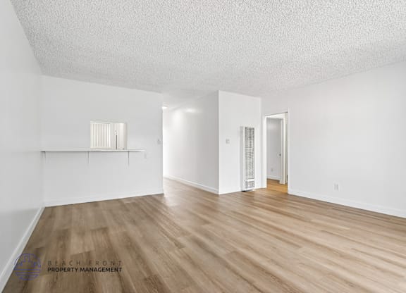 A room with wooden floors and white walls.