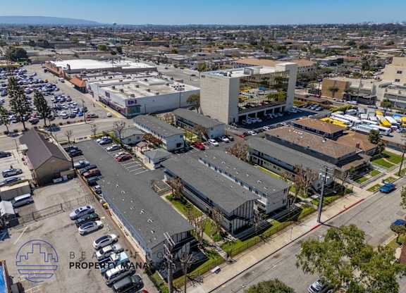 an aerial view of a parking lot and buildings in the city