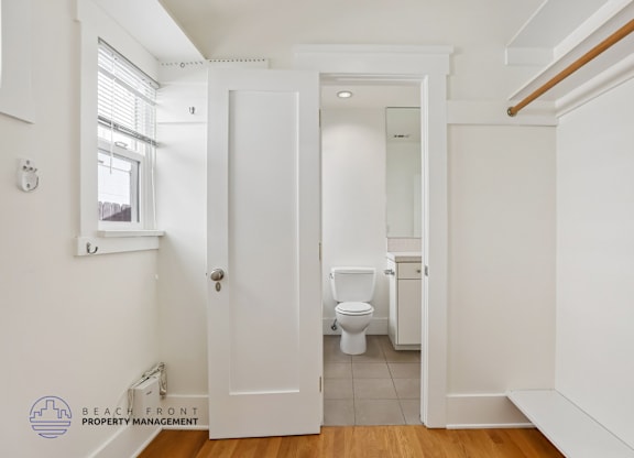 A white bathroom with a toilet and sink.